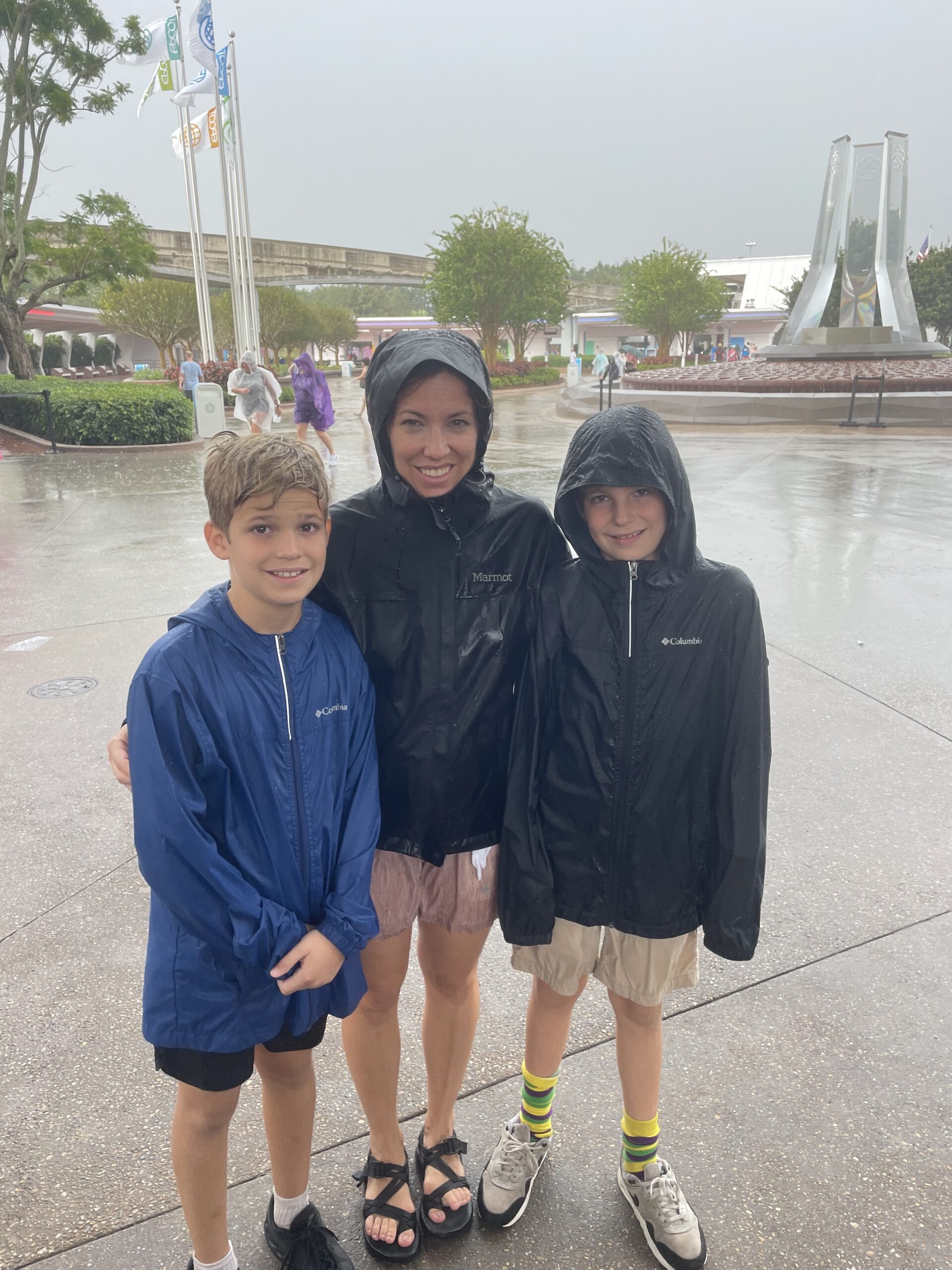 Dr. Brownfield with her sons in the rain at EPCOT